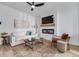 Bright living room featuring a modern ceiling fan, decorative fireplace and stylish furniture at 231 Ivey Ter, Temple, GA 30179