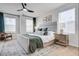 Bright primary bedroom with a large window, plush bedding, stylish furniture and modern decor at 231 Ivey Ter, Temple, GA 30179