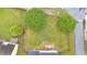 Aerial view of a sprawling backyard with mature trees, lush greenery, and a patio area at 2586 Abbotts Glen Nw Dr, Acworth, GA 30101