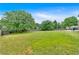 Expansive backyard with a lush lawn, a sturdy fence, and mature trees providing shade and privacy at 2586 Abbotts Glen Nw Dr, Acworth, GA 30101