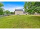 Large, well-maintained backyard with a privacy fence, lush greenery, and a charming patio area at 2586 Abbotts Glen Nw Dr, Acworth, GA 30101