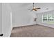 Spacious bedroom with ceiling fan, natural light, and carpeted floor at 2586 Abbotts Glen Nw Dr, Acworth, GA 30101