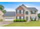 Charming two-story home with a brick and siding exterior, well-manicured lawn, and an attached two-car garage at 2586 Abbotts Glen Nw Dr, Acworth, GA 30101