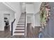Bright foyer with hardwood floors, staircase, and a decorative floral wreath on the front door at 2586 Abbotts Glen Nw Dr, Acworth, GA 30101