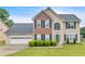 Charming two-story home with a brick facade, lush lawn and well-maintained landscaping at 2586 Abbotts Glen Nw Dr, Acworth, GA 30101