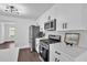 Modern kitchen featuring stainless steel appliances, white cabinets, and sleek countertops at 2586 Abbotts Glen Nw Dr, Acworth, GA 30101
