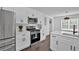 Well-lit kitchen with stainless steel appliances, white cabinets, modern countertops, and hardwood floors at 2586 Abbotts Glen Nw Dr, Acworth, GA 30101