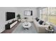 Living room featuring a white couch, large TV, and modern decor at 2586 Abbotts Glen Nw Dr, Acworth, GA 30101
