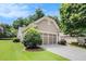 This home boasts a well-maintained lawn, two-car garage, and mature trees at 4445 Vanadium Bend, Cumming, GA 30040