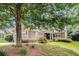Beautiful home with manicured lawn and mature trees providing ample shade at 4445 Vanadium Bend, Cumming, GA 30040