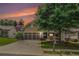 Inviting home exterior with well-kept lawn, mature trees, and cozy residential charm at sunset at 4445 Vanadium Bend, Cumming, GA 30040