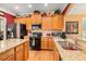 Well-lit kitchen with granite countertops, stainless steel appliances, and ample cabinet space at 4445 Vanadium Bend, Cumming, GA 30040