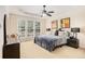 Spacious main bedroom features a tray ceiling, ceiling fan and a large window at 4445 Vanadium Bend, Cumming, GA 30040