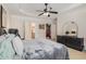 Spacious main bedroom features a tray ceiling, ceiling fan, closet, and large windows at 4445 Vanadium Bend, Cumming, GA 30040