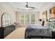 Spacious main bedroom features a tray ceiling, ceiling fan and a large window at 4445 Vanadium Bend, Cumming, GA 30040