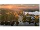 Aerial view of waterfront homes at sunset showing beautiful lake and treeline at 9058 Woodlake Lane, Villa Rica, GA 30180