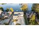 Stunning aerial view of a waterfront property with lush landscaping, a long driveway, and scenic lake views at 9058 Woodlake Lane, Villa Rica, GA 30180