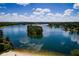 Lake view showcases the community island and tranquil blue waters at 9058 Woodlake Lane, Villa Rica, GA 30180