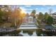 Backyard featuring a multi-tiered landscape design leading to the lake, complete with boat docks and a serene view at 9058 Woodlake Lane, Villa Rica, GA 30180