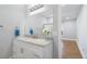 Bright bathroom with a large mirror, vanity, and a shower with glass doors at 9058 Woodlake Lane, Villa Rica, GA 30180