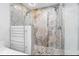 Modern bathroom featuring a glass-enclosed shower with dual shower heads, and heated towel rack at 9058 Woodlake Lane, Villa Rica, GA 30180