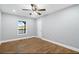 Cozy bedroom with hardwood floors, a ceiling fan, and a window view at 9058 Woodlake Lane, Villa Rica, GA 30180