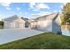 Rear exterior view of waterfront home with attached two-car garage and lakeside access at 9058 Woodlake Lane, Villa Rica, GA 30180