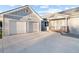 Front exterior view featuring a two-car garage, covered porch, and concrete driveway at 9058 Woodlake Lane, Villa Rica, GA 30180
