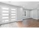 Bright foyer with stylish front doors, hardwood floors, and neutral paint creating an open and airy entrance at 9058 Woodlake Lane, Villa Rica, GA 30180