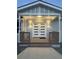 Inviting front entrance featuring double doors, a covered porch, and decorative lighting creating a warm and welcoming ambiance at 9058 Woodlake Lane, Villa Rica, GA 30180