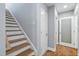 Hallway and stairway with wooden steps and white risers at 9058 Woodlake Lane, Villa Rica, GA 30180