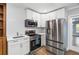 Modern kitchen with stainless steel appliances and white cabinetry at 9058 Woodlake Lane, Villa Rica, GA 30180