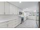 Bright kitchen featuring white cabinetry, quartz countertops, stainless steel appliances, and a kitchen island at 9058 Woodlake Lane, Villa Rica, GA 30180