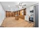 Open concept living room features hardwood floors, built-in bookshelves, and modern appliances at 9058 Woodlake Lane, Villa Rica, GA 30180