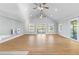 Spacious living room with vaulted ceilings, hardwood floors, multiple windows, and sliding door to deck at 9058 Woodlake Lane, Villa Rica, GA 30180