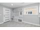 Mudroom with bench seating, storage cubbies, hooks, and a large window at 9058 Woodlake Lane, Villa Rica, GA 30180
