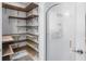 Walk-in pantry features wood shelving, an etched glass door, and ample storage space at 9058 Woodlake Lane, Villa Rica, GA 30180
