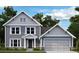 Charming two-story home featuring a classic gray exterior, well-manicured lawn, and attached two-car garage at 155 Pickens Bluff Ln, Hiram, GA 30141