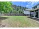 Large backyard with wood fence and an enclosed porch at 2020 Walking Horse Trl, Cumming, GA 30041