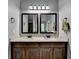 Bathroom featuring double vanity with granite countertops, framed mirrors, and towel rings at 2020 Walking Horse Trl, Cumming, GA 30041