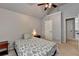 Bright bedroom with a ceiling fan, overhead light, and neutral color walls at 2020 Walking Horse Trl, Cumming, GA 30041