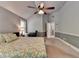 Bright bedroom with ceiling fan, a desk nook, and en-suite bathroom access at 2020 Walking Horse Trl, Cumming, GA 30041
