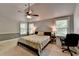 Large primary bedroom featuring a ceiling fan, and sunny windows at 2020 Walking Horse Trl, Cumming, GA 30041