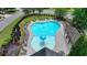 Aerial view of a large community pool with lounge chairs, tables, umbrellas, and a splash fountain for residents at 2020 Walking Horse Trl, Cumming, GA 30041