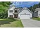 Charming two-story home with a well-manicured lawn and attached two car garage at 2020 Walking Horse Trl, Cumming, GA 30041