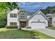 Attractive two-story home with a well-maintained lawn and an attached two-car garage at 2020 Walking Horse Trl, Cumming, GA 30041