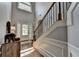 Bright foyer with hardwood floors, staircase with iron spindles and trim details at 2020 Walking Horse Trl, Cumming, GA 30041