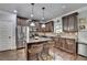 Well-equipped kitchen featuring dark cabinets, stainless appliances, and breakfast bar at 2020 Walking Horse Trl, Cumming, GA 30041