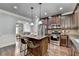 Well-equipped kitchen featuring dark cabinets, stainless appliances, and a breakfast bar at 2020 Walking Horse Trl, Cumming, GA 30041