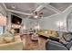 Inviting living room with stone fireplace, coffered ceilings, and hardwood flooring for a cozy ambiance at 2020 Walking Horse Trl, Cumming, GA 30041